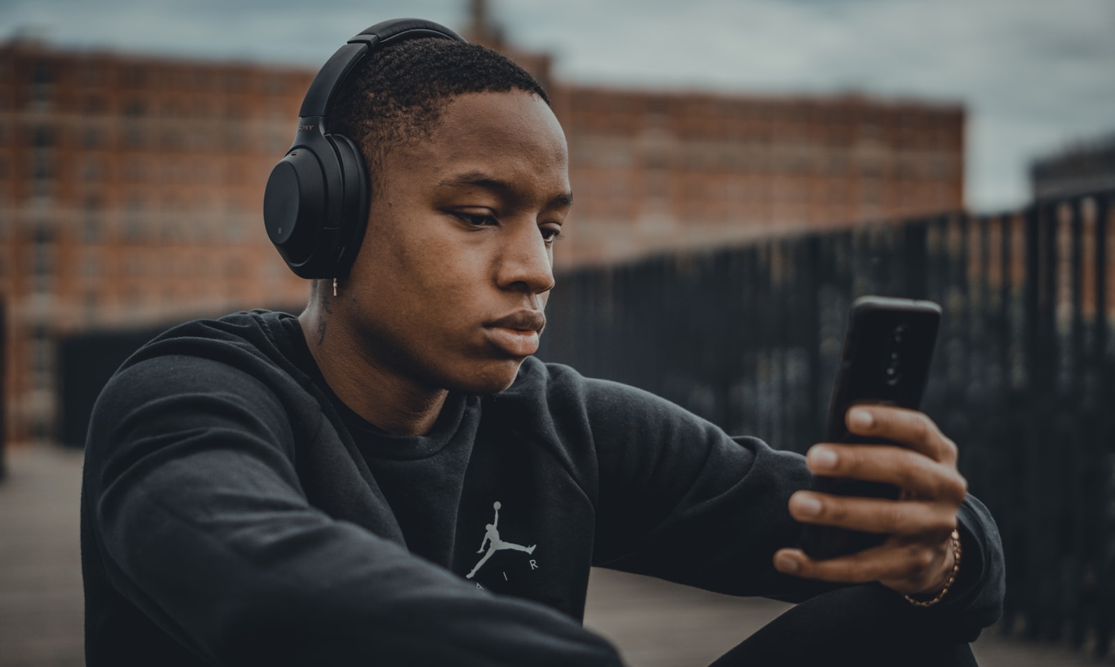 Generated on-model shot: the same headphones worn outdoors