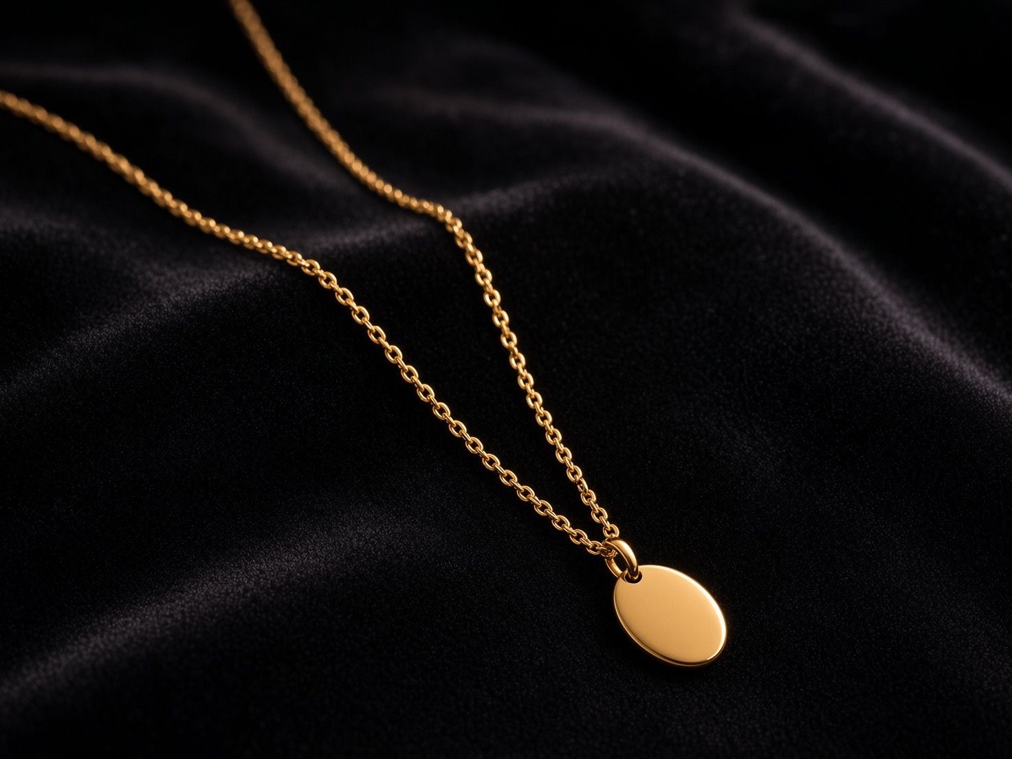 Studio packshot: the gold pendant on black velvet