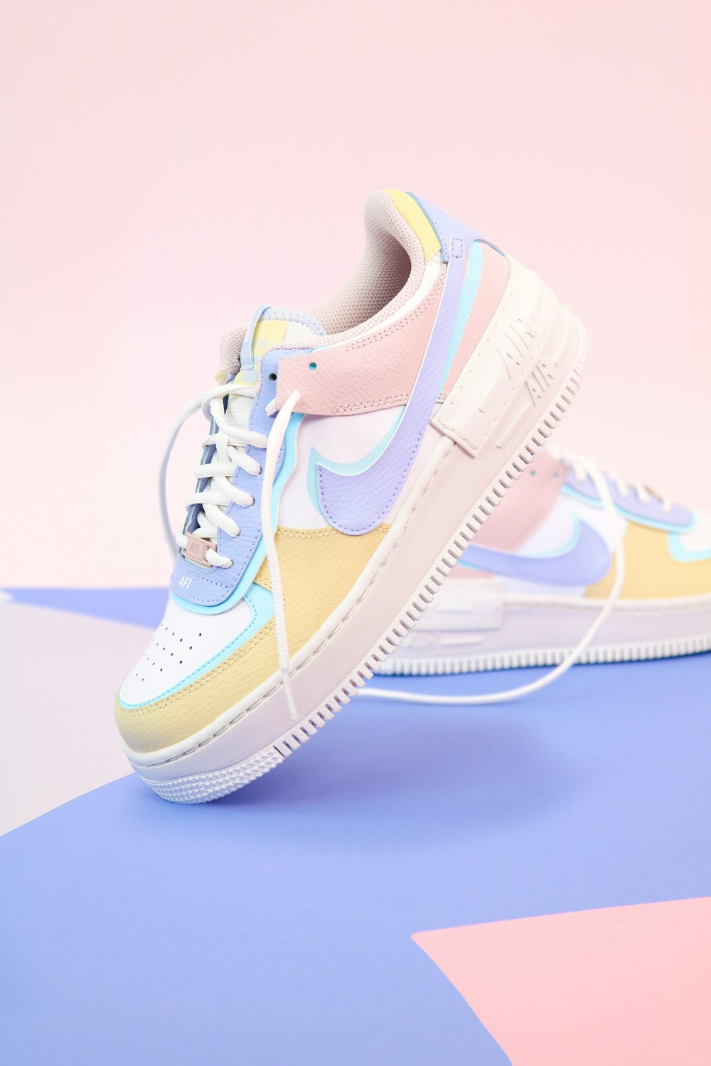 Lifestyle scene: pastel low-top sneakers on a colour-blocked set